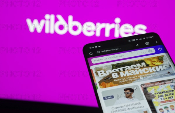 Dhaka, Bangladesh- 03 July 2025: Smartphone displaying Wildberries web interface against Wildberries logo background