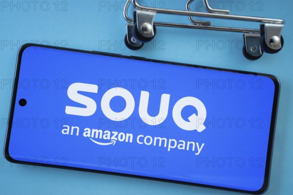 Dhaka, Bangladesh- 03 July 2025: Smartphone screen showing the Souq logo with shopping cart wheels on a blue background