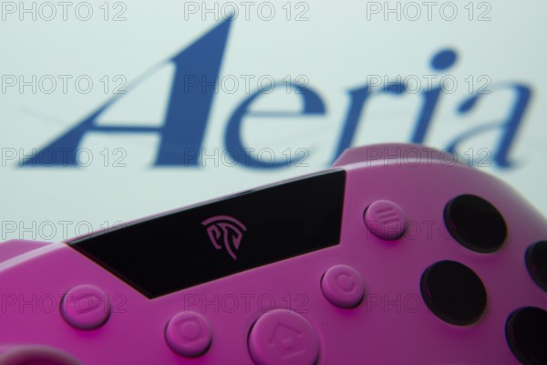 Dhaka, Bangladesh- 23 Sep 2025: A close-up of a gamepad with the Aeria seen on screen in the background