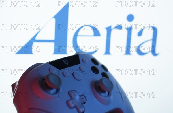 Dhaka, Bangladesh- 23 Sep 2025: A close-up of a gamepad with the Aeria seen on screen in the background