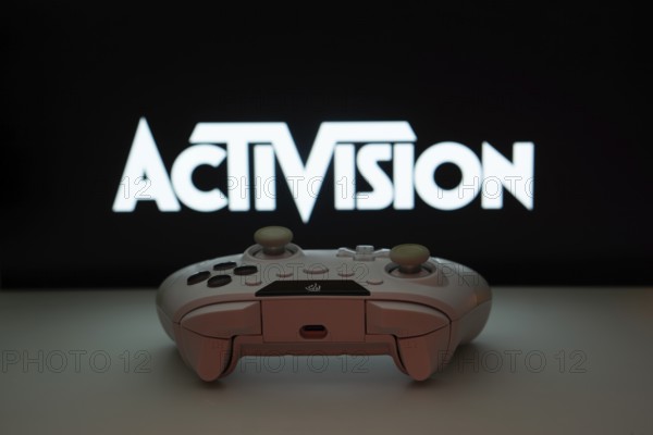 Dhaka, Bangladesh- 23 Sep 2025: A close-up of a white gamepad with the Activision seen on screen in the background