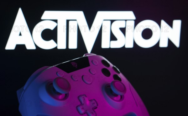 Dhaka, Bangladesh- 23 Sep 2025: A close-up of a white gamepad with the Activision seen on screen in the background