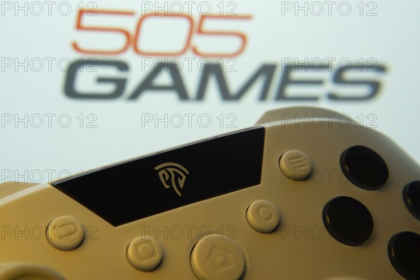 Dhaka, Bangladesh- 23 Sep 2025: A close-up of a gamepad with the 505 Games seen on screen in the background