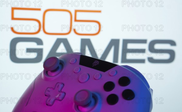 Dhaka, Bangladesh- 23 Sep 2025: A close-up of a gamepad with the 505 Games seen on screen in the background