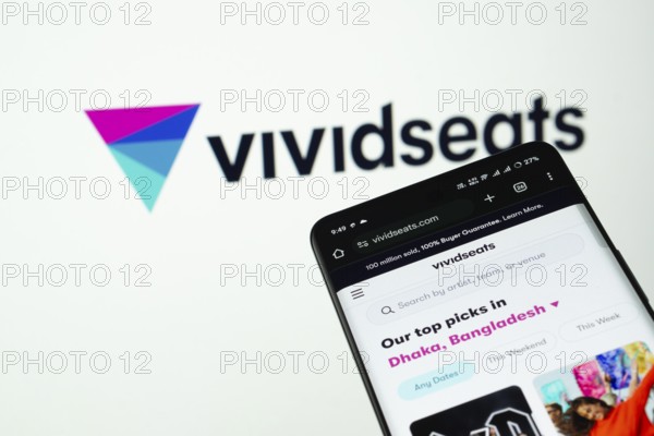 Dhaka, Bangladesh- 03 July 2025: Smartphone displaying VividSeats web interface against (....) logo background
