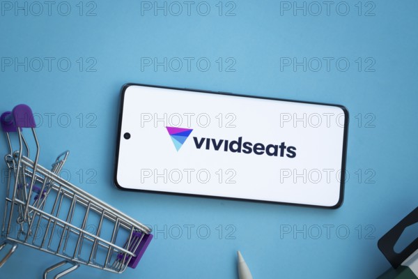 Dhaka, Bangladesh- 03 July 2025: Smartphone displaying VividSeats logo with shopping cart on a blue background
