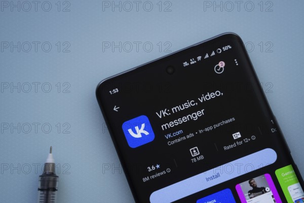 Dhaka, Bangladesh- 29 May 2025: On a blue surface, a smartphone displays the VK app within the Google Play Store