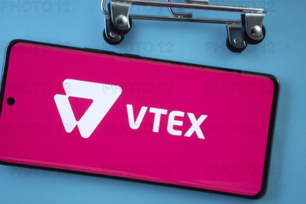 Dhaka, Bangladesh- 03 July 2025: Smartphone screen showing the VTEX logo with shopping cart wheels on a blue background