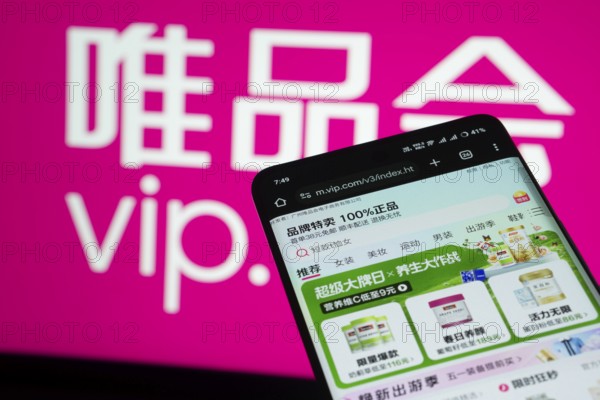 Dhaka, Bangladesh- 03 July 2025: Smartphone displaying vip.com web interface against vip.com logo background