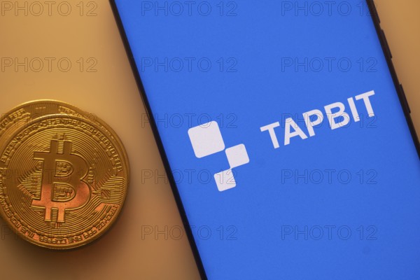 A Bitcoin and Tapbit logo on a blue screen representing cryptocurrency