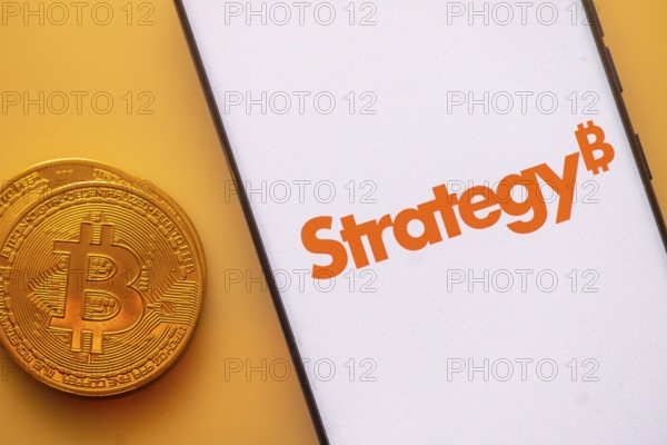 A Bitcoin and Strategy logo on a white screen with orange text