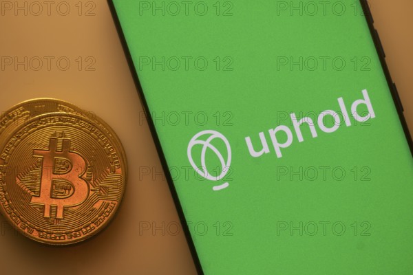 A Bitcoin coin next to an Uphold logo on a green background