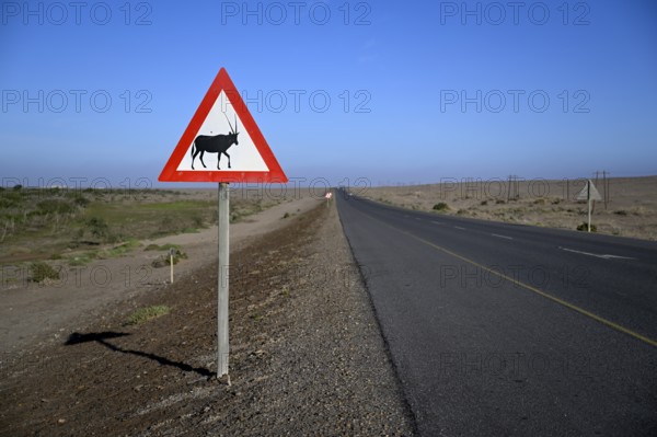 Beware of oryx antelopes (Oryx gazella) sign on a road near Oranjemund, Diamond Sperrgebiet, Karas Region, Namibia