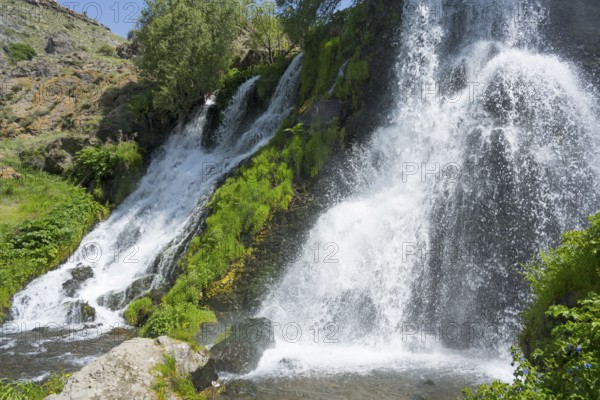 A rushing waterfall flows over moss-covered rocks in a green setting, Shaki Waterfall, Shaki, Syunik Province, Armenia