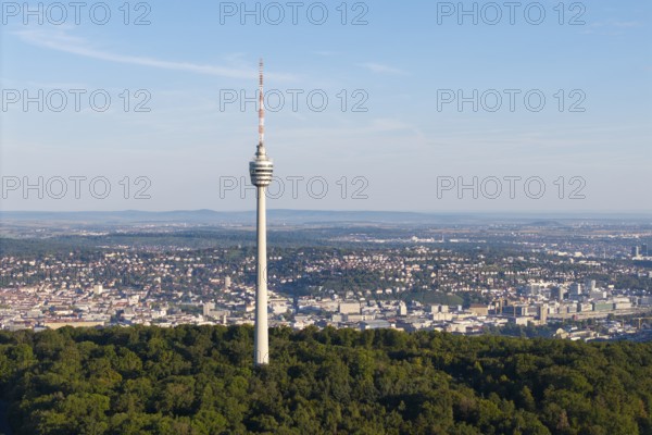 A tall television tower is surrounded by a green forest landscape under a clear sky, Stuttgart, Baden-Württemberg, Germany