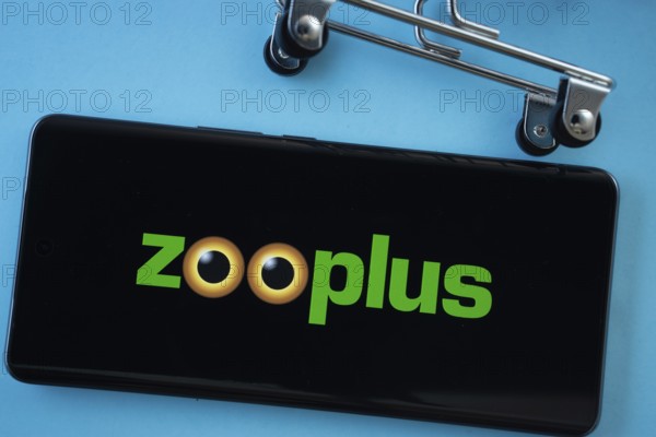 Dhaka, Bangladesh- 03 July 2025: Smartphone screen showing the zooplus logo with shopping cart wheels on a blue background