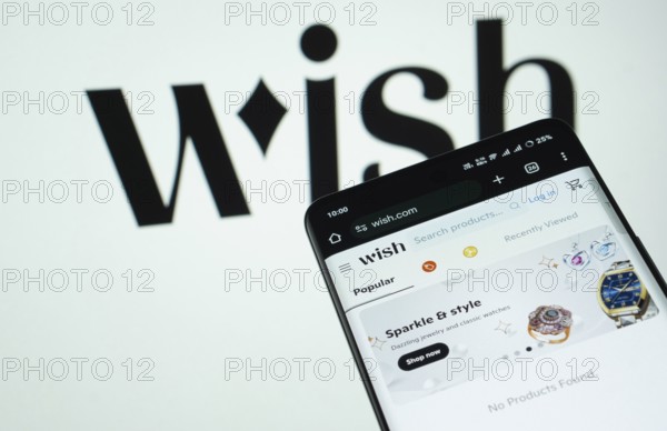 Dhaka, Bangladesh- 03 July 2025: Smartphone displaying Wish web interface against wish logo background