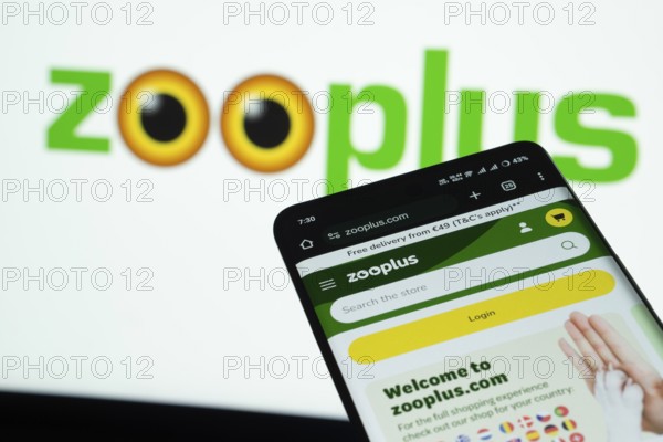 Dhaka, Bangladesh- 03 July 2025: Smartphone displaying zooplus web interface against Zooplus logo background