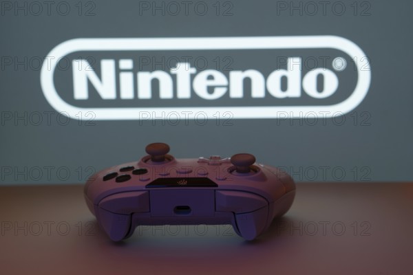 Dhaka, Bangladesh- 15 July 2025: A close-up of a gamepad with the nintendo seen on screen in the background