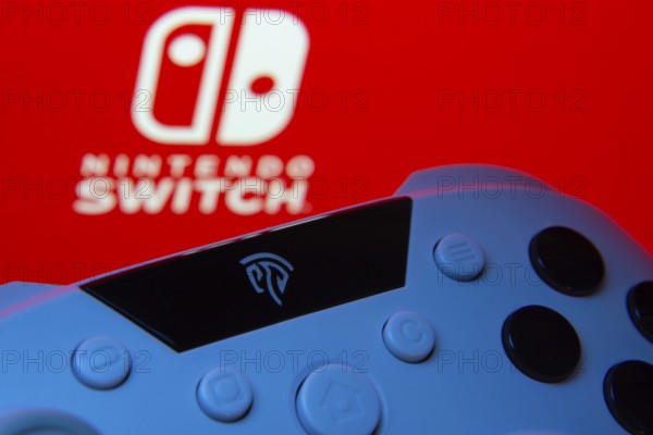 Dhaka, Bangladesh- 15 July 2025: A close-up of a gamepad with thenintendo switch seen on screen in the background
