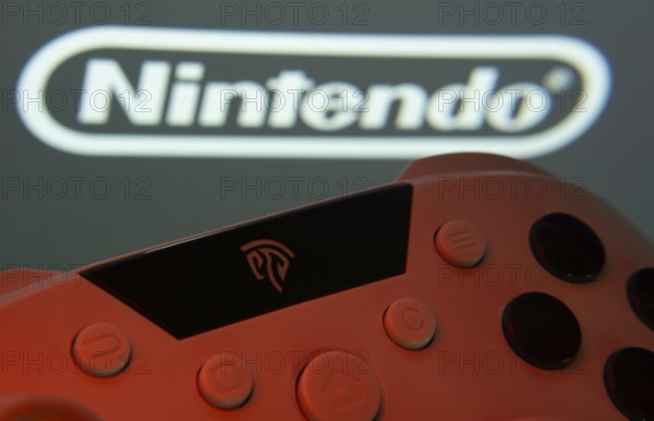 Dhaka, Bangladesh- 15 July 2025: A close-up of a gamepad with the nintendo seen on screen in the background