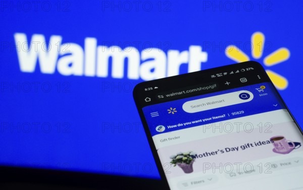 Dhaka, Bangladesh- 03 July 2025: Smartphone displaying Walmart web interface against Walmart logo background