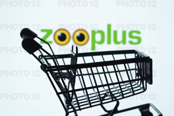 Dhaka, Bangladesh- 03 July 2025: Silhouette of a shopping cart in front of the zooplus logo, symbolizing ecommerce and online shopping