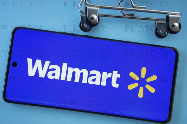 Dhaka, Bangladesh- 03 July 2025: Smartphone screen showing the Walmart logo with shopping cart wheels on a blue background