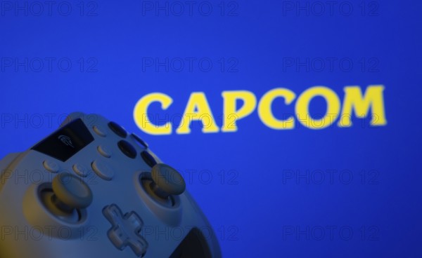 Dhaka, Bangladesh- 15 Sep 2025: A close-up of a gamepad with the Capcom seen on screen in the background
