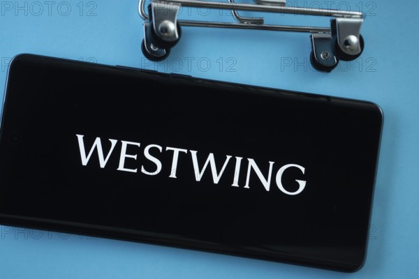 Dhaka, Bangladesh- 03 July 2025: Smartphone screen showing the Westwing logo with shopping cart wheels on a blue background