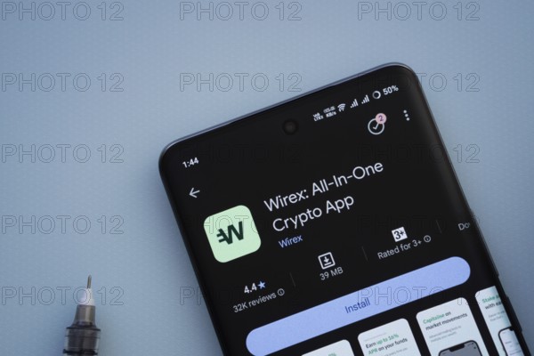 Dhaka, Bangladesh- 29 May 2025: On a blue surface, a smartphone displays the wirex app within the Google Play Store