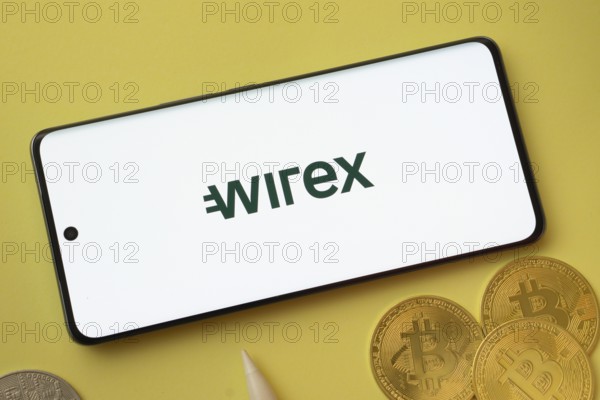 Dhaka, Bangladesh- 26 Aug 2025: wirex logo on smartphone screen near Bitcoin coin and QR code on background