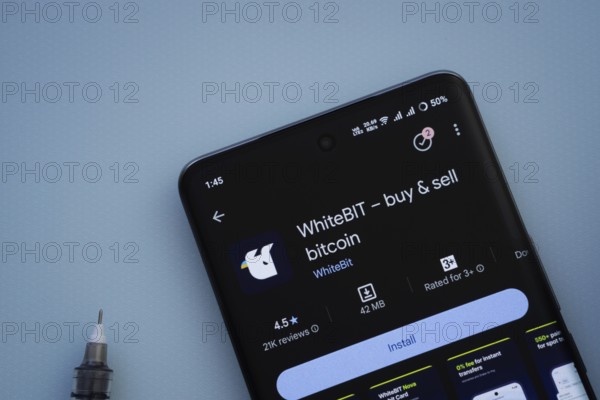 Dhaka, Bangladesh- 29 May 2025: On a blue surface, a smartphone displays the Whitebit app within the Google Play Store