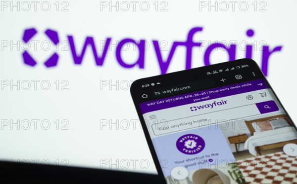Dhaka, Bangladesh- 03 July 2025: Smartphone displaying Wayfair web interface against Wayfair logo background