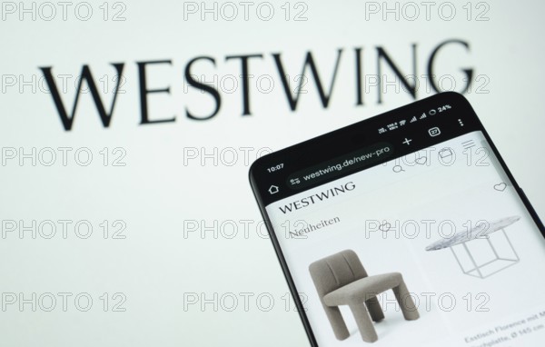 Dhaka, Bangladesh- 03 July 2025: Smartphone displaying Westwing web interface against Westwing logo background
