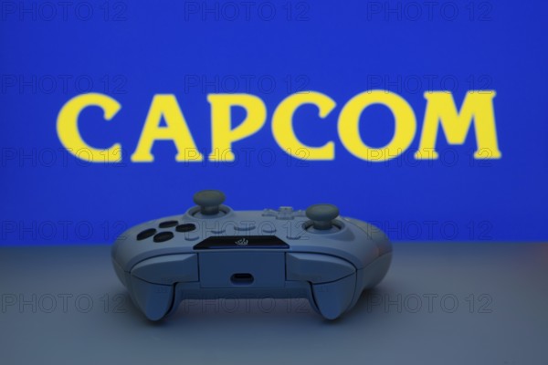 Dhaka, Bangladesh- 19 Sep 2025: A close-up of a white gamepad with the Capcom seen on screen in the background