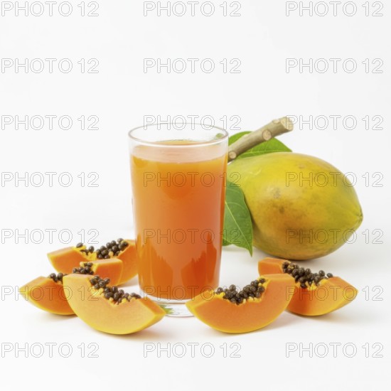 A refreshing glass of papaya juice is surrounded by fresh papaya slices and a whole papaya fruit, all set against a clean white backdrop, AI generated