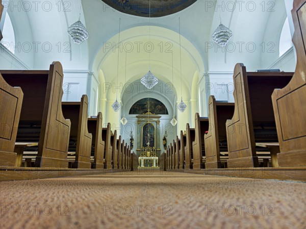 Church interior with view of the altar, wooden benches and quiet atmosphere, Kammersdorf Hollabrunn Weinviertel Lower Austria Austria