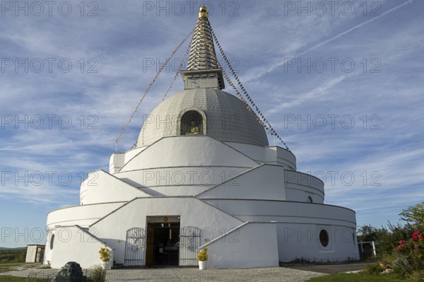 White stupa with an entrance under a clear blue sky, peaceful atmosphere, Stupa am Wagram Grafenwörth Weinviertel Lower Austria Austria