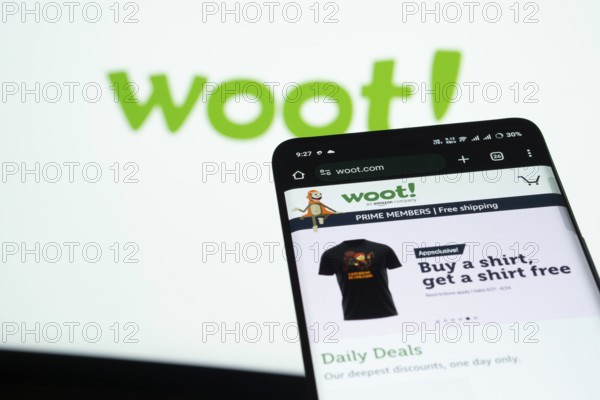 Dhaka, Bangladesh- 03 July 2025: Smartphone displaying Woot web interface against woot logo background