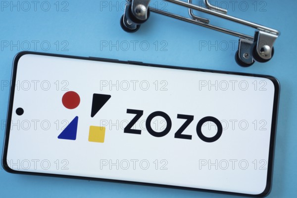 Dhaka, Bangladesh- 03 July 2025: Smartphone screen showing the ZOZO logo with shopping cart wheels on a blue background
