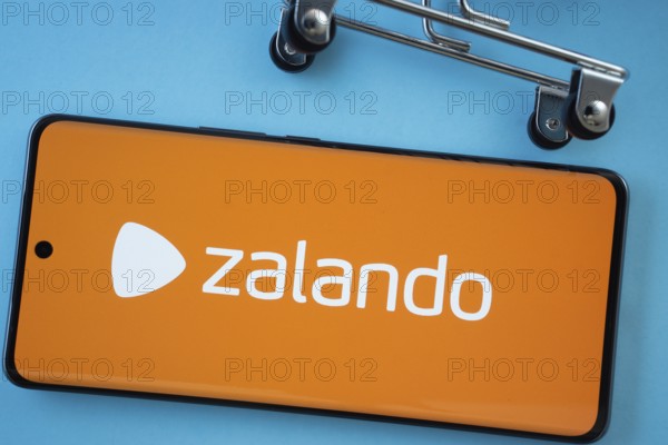 Dhaka, Bangladesh- 03 July 2025: Smartphone screen showing the Zalando logo with shopping cart wheels on a blue background