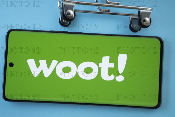 Dhaka, Bangladesh- 03 July 2025: Smartphone screen showing the Woot logo with shopping cart wheels on a blue background