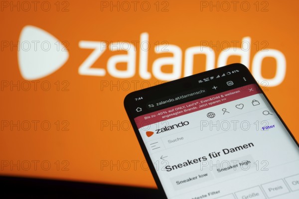 Dhaka, Bangladesh- 03 July 2025: Smartphone displaying Zalando web interface against Zalando logo background