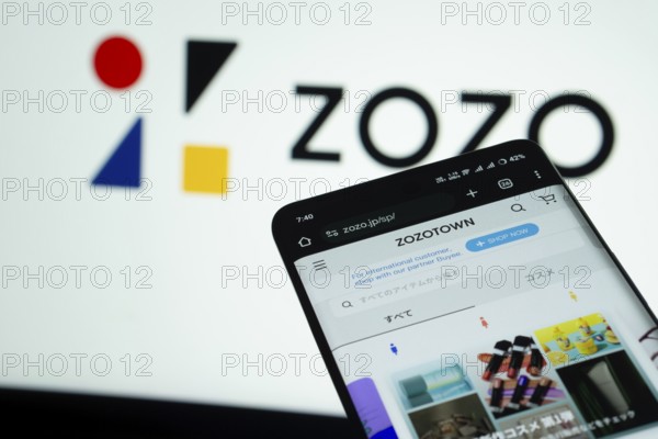Dhaka, Bangladesh- 03 July 2025: Smartphone displaying ZOZO web interface against ZOZO logo background
