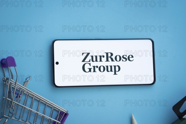 Dhaka, Bangladesh- 03 July 2025: Smartphone displaying Zur Rose Group logo with shopping cart on a blue background
