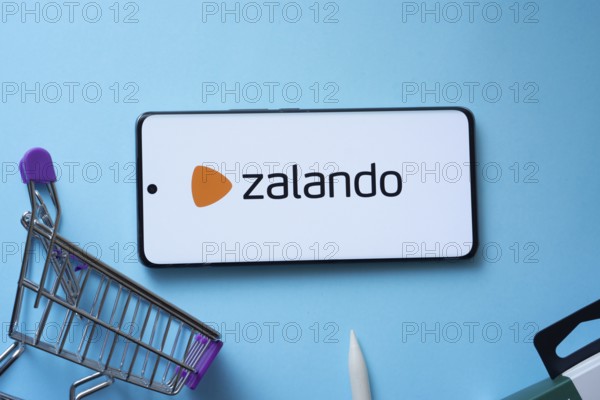 Dhaka, Bangladesh- 03 July 2025: Smartphone displaying Zalando logo with shopping cart on a blue background