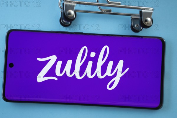 Dhaka, Bangladesh- 03 July 2025: Smartphone screen showing the Zulily logo with shopping cart wheels on a blue background