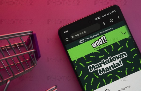 Dhaka, Bangladesh- 23 June 2025: A smartphone displaying the Woot website with a shopping cart is shown on a vibrant background