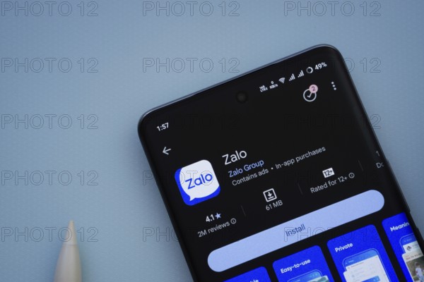 Dhaka, Bangladesh- 29 May 2025: On a blue surface, a smartphone displays the Zalo app within the Google Play Store